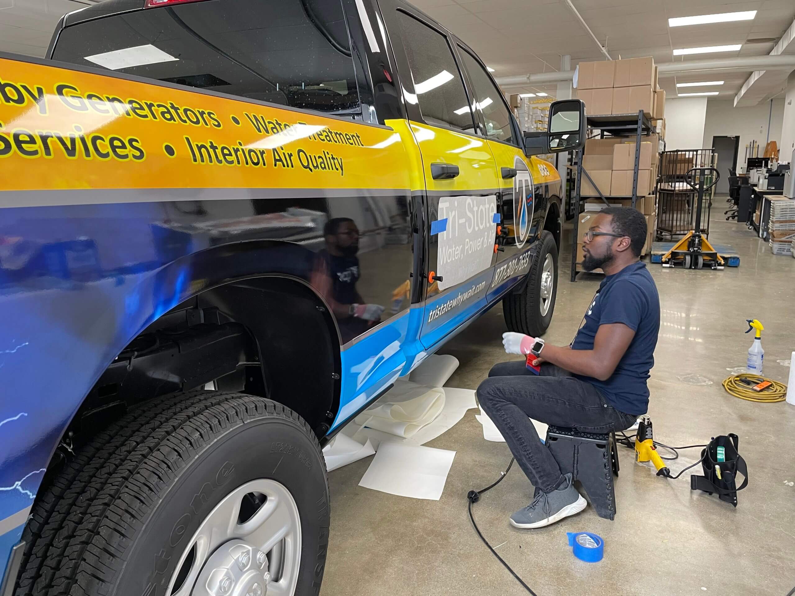 Chris working on Tri-State Water, Power, & Air Truck Wrap